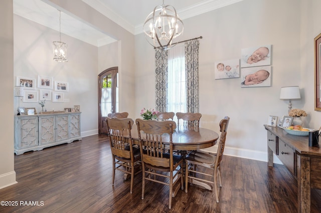 dining room with baseboards, a notable chandelier, and crown molding