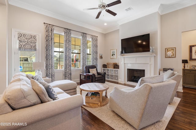 living room with a ceiling fan, dark wood finished floors, and a healthy amount of sunlight