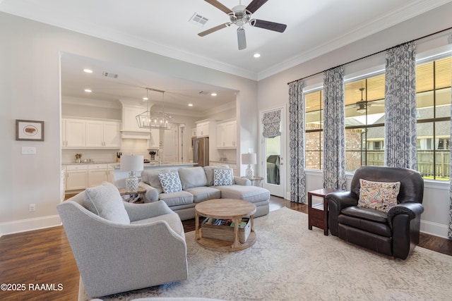 living room featuring baseboards, ornamental molding, dark wood-type flooring, and visible vents