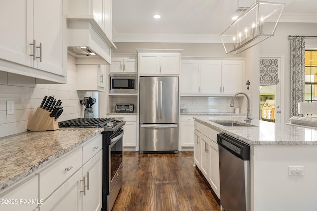kitchen featuring a sink, appliances with stainless steel finishes, white cabinetry, dark wood finished floors, and ornamental molding