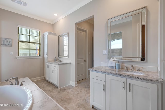 bathroom with a sink, a tub, baseboards, ornamental molding, and two vanities