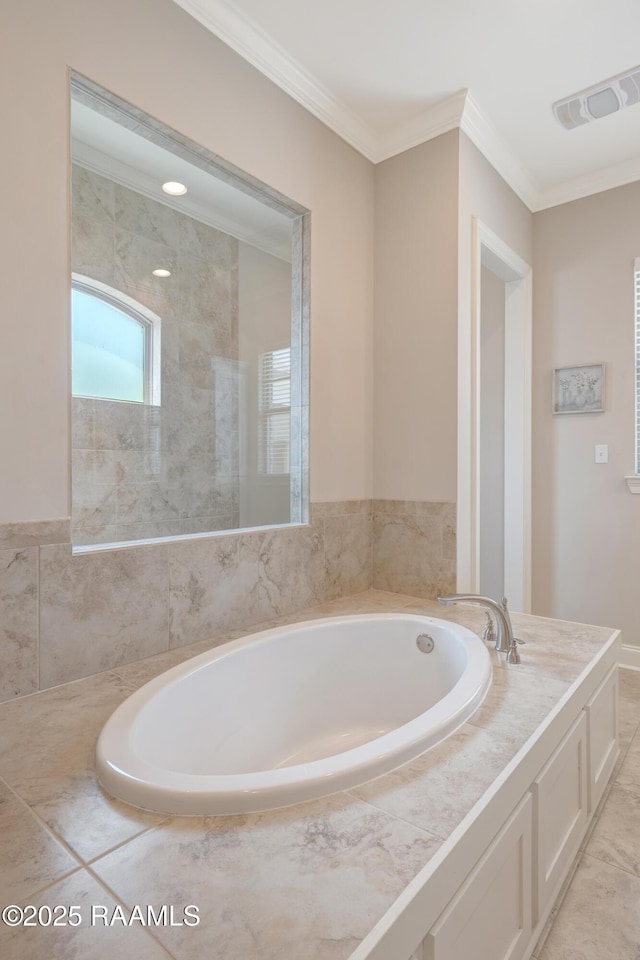 bathroom with a bath, visible vents, and ornamental molding
