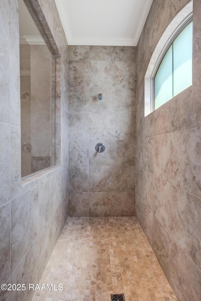 full bath featuring ornamental molding and tiled shower
