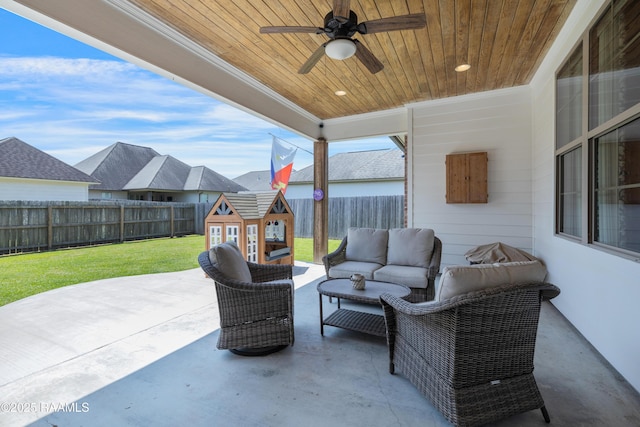 view of patio / terrace with a fenced backyard, an outdoor structure, an outdoor living space, and a ceiling fan