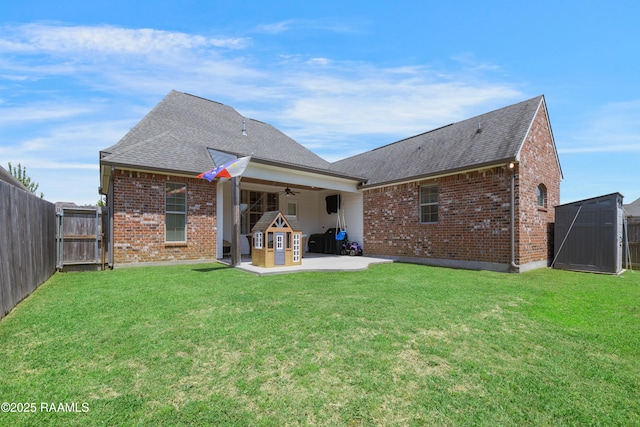 back of house with a patio area, a shingled roof, brick siding, and ceiling fan