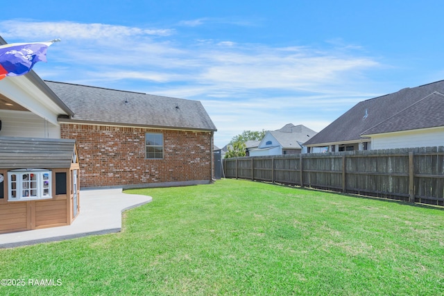 view of yard with a patio area and a fenced backyard