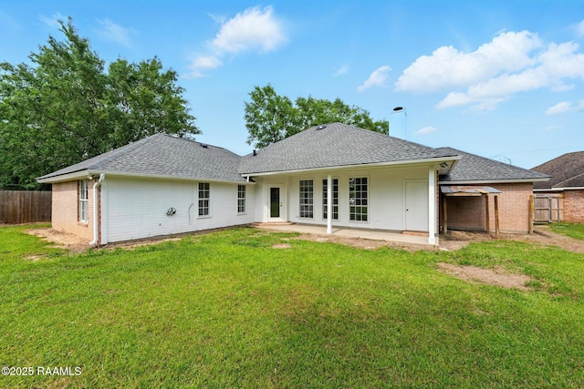 back of property featuring a patio, fence, and a shingled roof