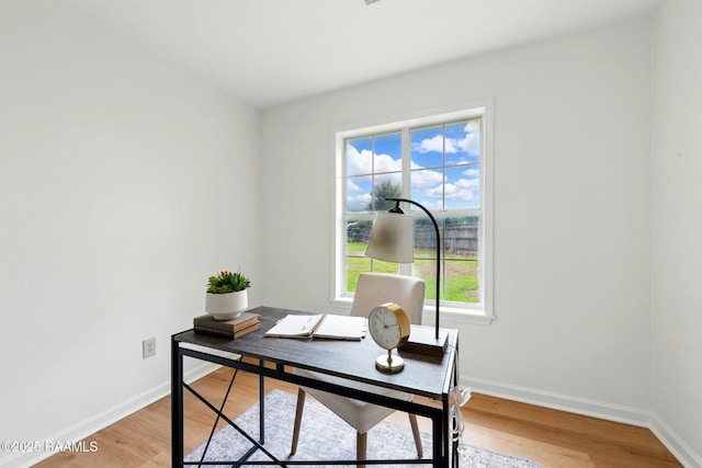 office area with baseboards and light wood-type flooring