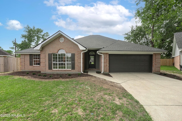 ranch-style house with a garage, fence, a front yard, and concrete driveway