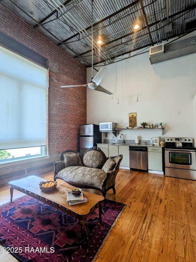 403 S Buchanan St Unit 8, Lafayette, LA 70501 - living room featuring brick wall and wood-type flooring