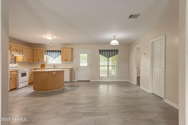 kitchen featuring white range with electric stovetop, light countertops, baseboards, and under cabinet range hood