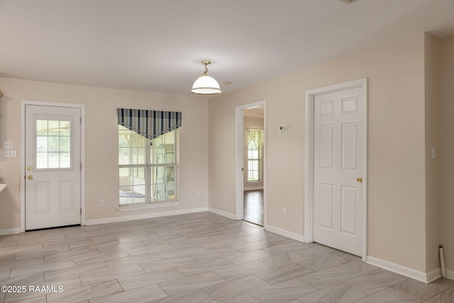 interior space with a wealth of natural light and baseboards