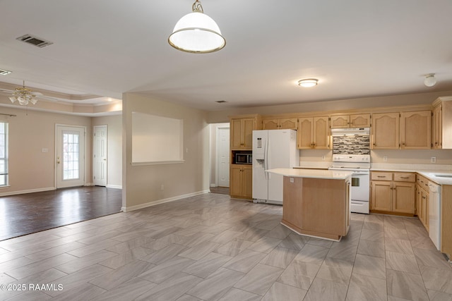 kitchen with under cabinet range hood, white appliances, light brown cabinetry, light countertops, and open floor plan