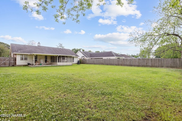view of yard featuring a patio area and a fenced backyard