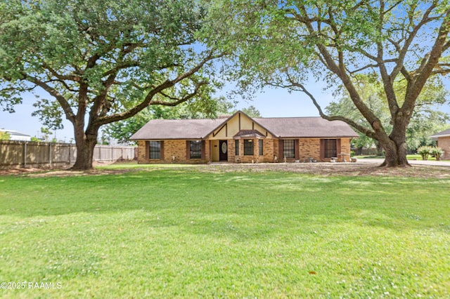 103 Failla Rd, Lafayette, LA 70508 - english style home featuring a front lawn and fence