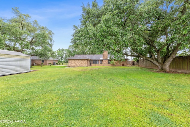103 Failla Rd, Lafayette, LA 70508 - view of yard with fence, an outdoor structure, and a storage shed