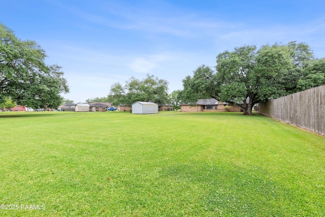 103 Failla Rd, Lafayette, LA 70508 - view of yard featuring fence, an outbuilding, and a storage shed