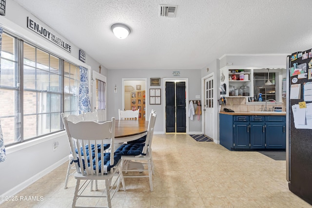 103 Failla Rd, Lafayette, LA 70508 - dining space featuring a textured ceiling, visible vents, and baseboards