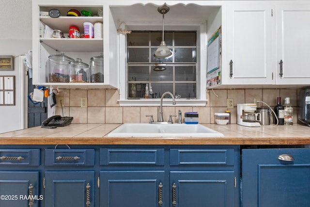 103 Failla Rd, Lafayette, LA 70508 - interior space with decorative light fixtures, tasteful backsplash, and a sink