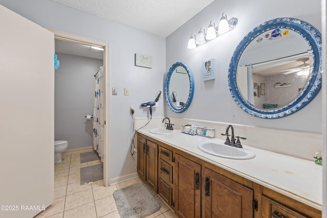 103 Failla Rd, Lafayette, LA 70508 - bathroom featuring tile patterned floors, double vanity, toilet, a sink, and a textured ceiling