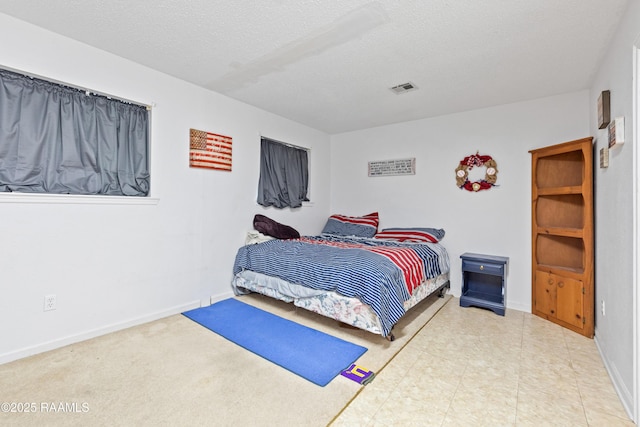103 Failla Rd, Lafayette, LA 70508 - bedroom featuring a textured ceiling, baseboards, and visible vents