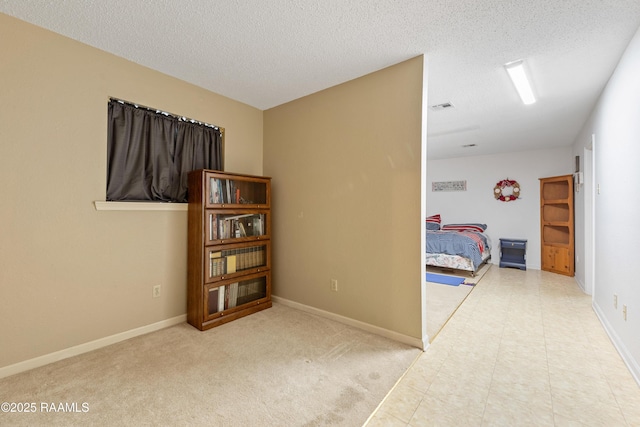 103 Failla Rd, Lafayette, LA 70508 - bedroom with baseboards, visible vents, and a textured ceiling