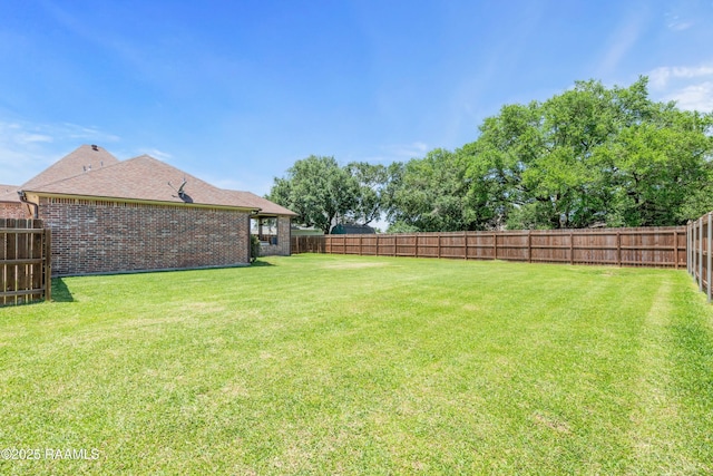view of yard with a fenced backyard