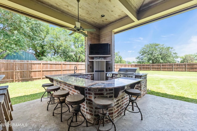 view of patio with a sink, a grill, a fenced backyard, area for grilling, and outdoor wet bar