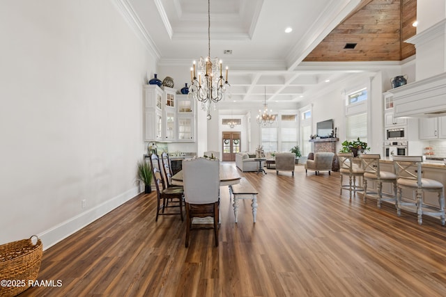dining room with baseboards, a notable chandelier, dark wood-style floors, and ornamental molding