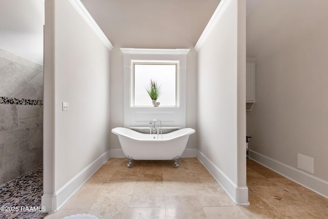 bathroom with crown molding, tile patterned flooring, baseboards, walk in shower, and a freestanding bath