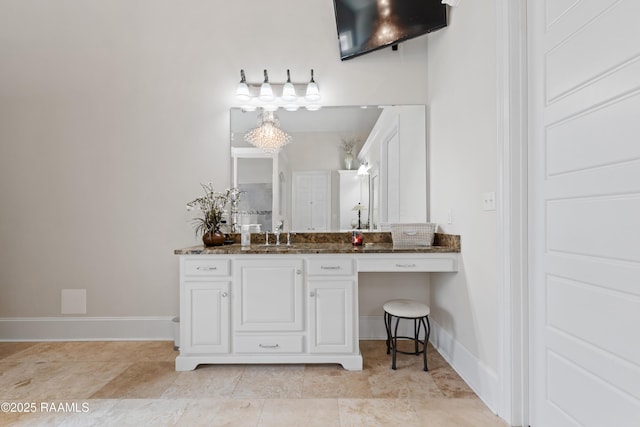 bathroom featuring vanity and baseboards