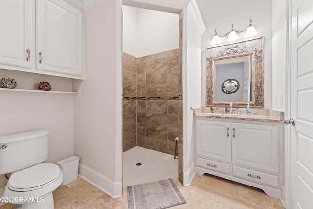 full bathroom featuring tile patterned flooring, vanity, baseboards, toilet, and tiled shower