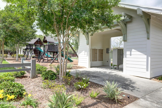 exterior space featuring fence and a playground