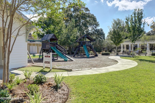 community playground featuring a lawn and fence