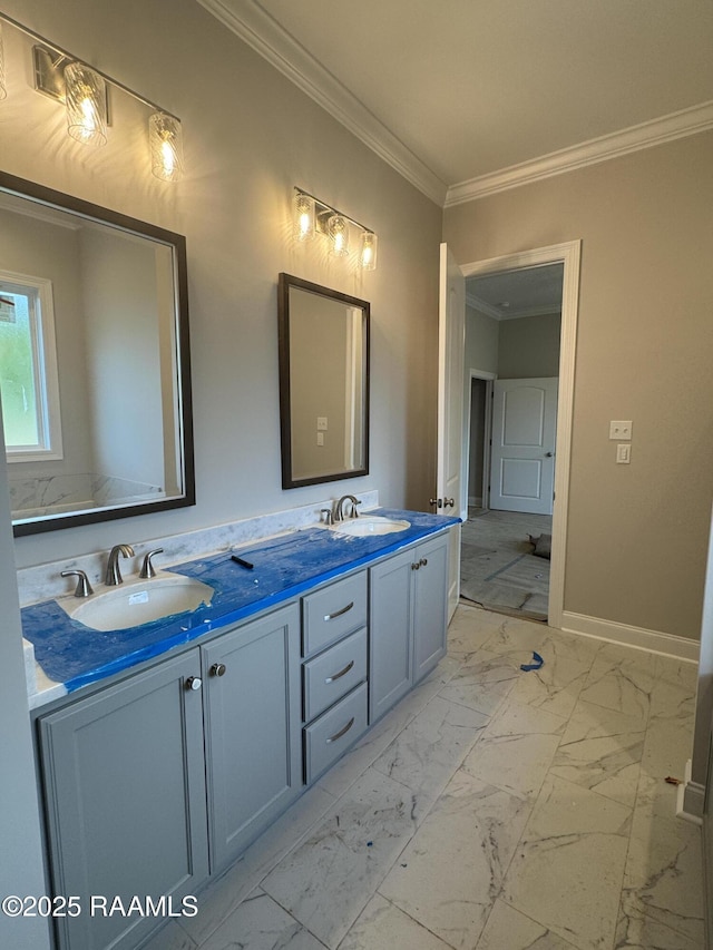 full bath featuring ornamental molding, marble finish floor, double vanity, and a sink