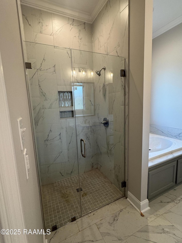 bathroom featuring a bath, ornamental molding, marble finish floor, and a marble finish shower