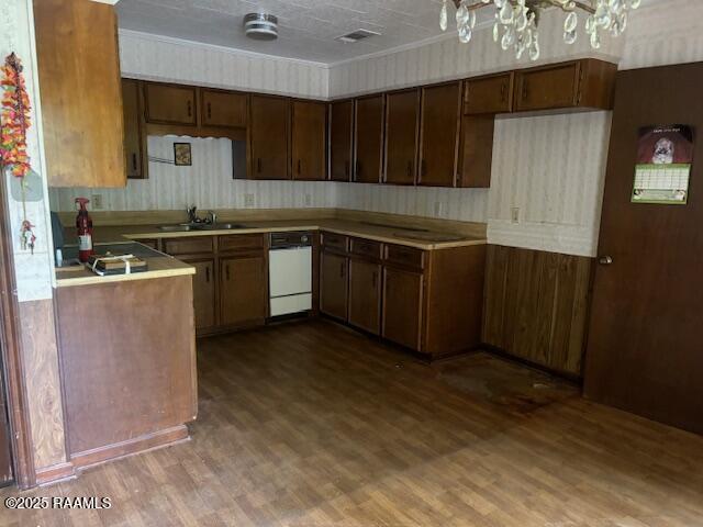 1614 Norway St, Opelousas, LA 70570 - kitchen with a sink, dark wood finished floors, dishwasher, and light countertops