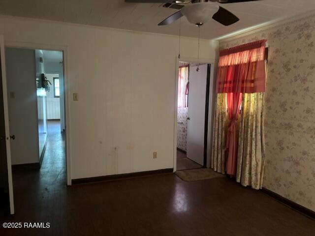 1614 Norway St, Opelousas, LA 70570 - empty room featuring plenty of natural light, ceiling fan, wallpapered walls, and baseboards