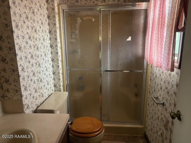 1614 Norway St, Opelousas, LA 70570 - full bath featuring wallpapered walls, a stall shower, toilet, and vanity