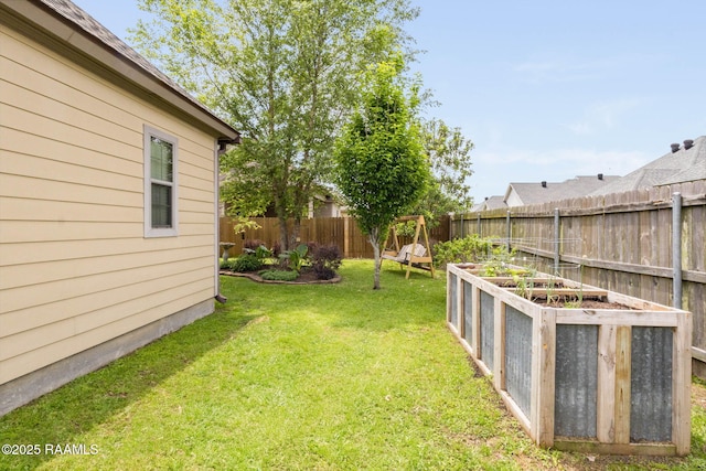view of yard with a fenced backyard and a garden