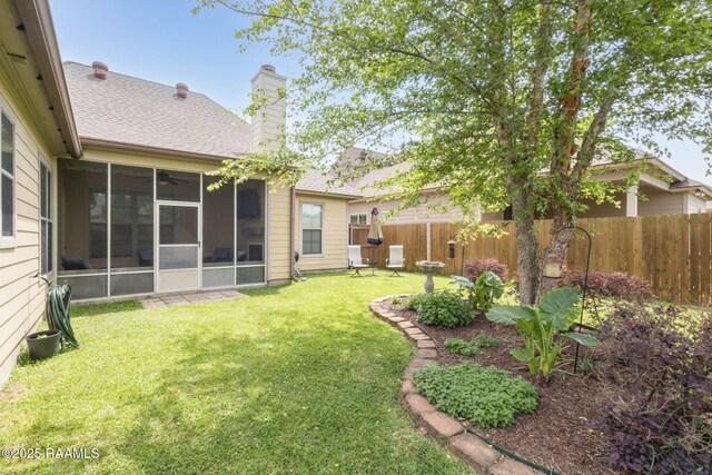 view of yard featuring a sunroom and fence