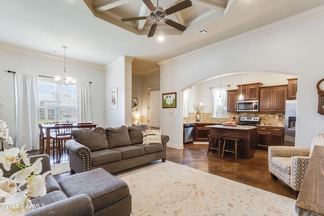 living room with coffered ceiling, visible vents, ornamental molding, arched walkways, and ceiling fan with notable chandelier