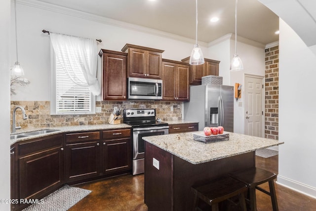 kitchen featuring a kitchen breakfast bar, a sink, arched walkways, decorative backsplash, and appliances with stainless steel finishes