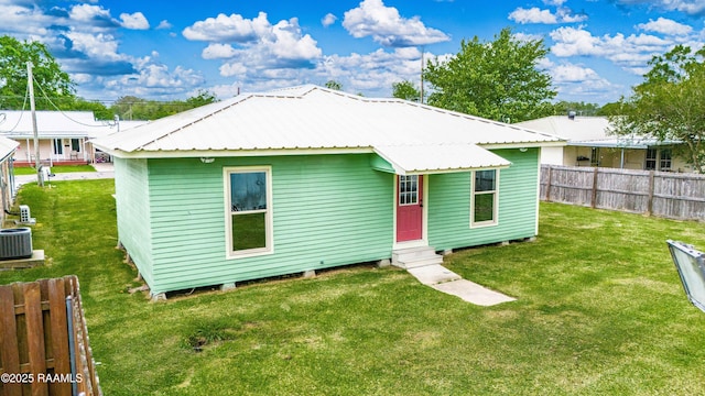 813 S Arenas St, Rayne, LA 70578 - rear view of property featuring fence, entry steps, a yard, and cooling unit
