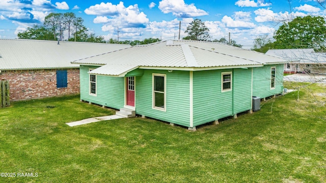 813 S Arenas St, Rayne, LA 70578 - rear view of property with a yard, entry steps, and metal roof