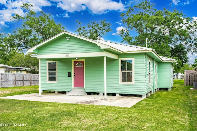 813 S Arenas St, Rayne, LA 70578 - bungalow-style home featuring cooling unit, metal roof, fence, a patio area, and a front yard