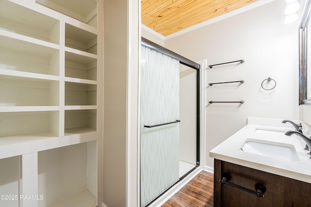 813 S Arenas St, Rayne, LA 70578 - full bathroom with a shower stall, double vanity, wood finished floors, a sink, and crown molding