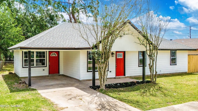 906 Priscilla Ln, Lafayette, LA 70501 - ranch-style home with roof with shingles, a front lawn, an attached carport, concrete driveway, and fence