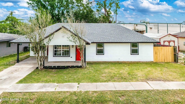 906 Priscilla Ln, Lafayette, LA 70501 - view of front of home with roof with shingles, a front lawn, a carport, driveway, and fence