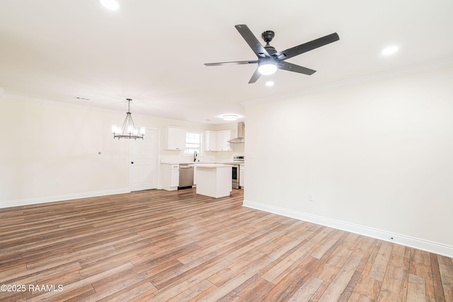 906 Priscilla Ln, Lafayette, LA 70501 - unfurnished living room featuring recessed lighting, crown molding, light wood-style flooring, and ceiling fan with notable chandelier